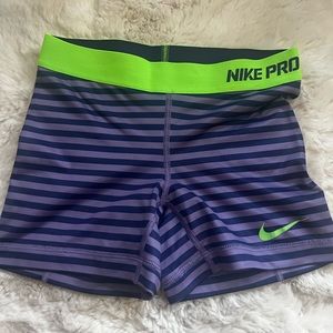 Nike purple striped spandex compression shorts with a lime green band, size xs